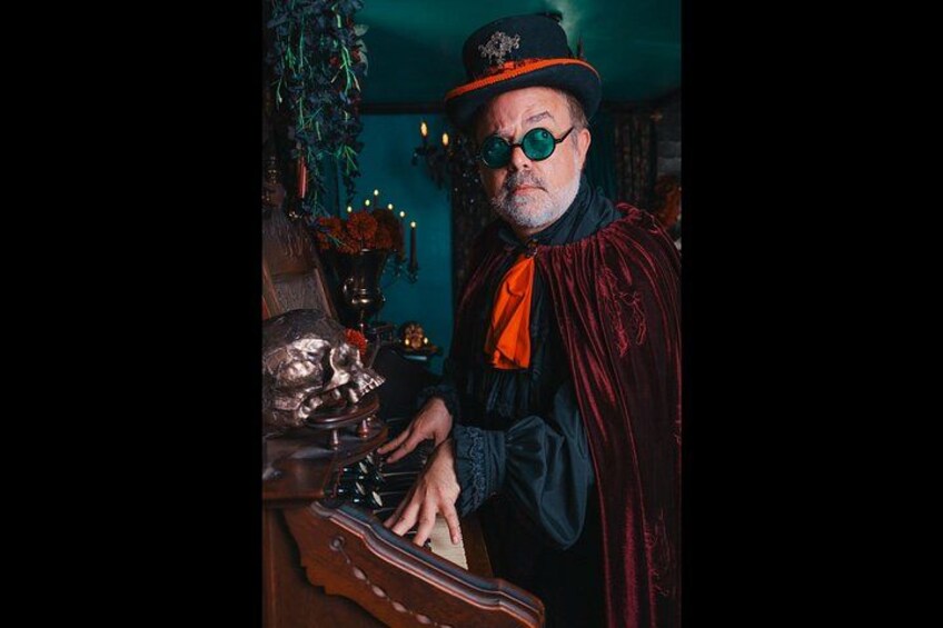 A person in a dark, vintage costume playing a piano. 3