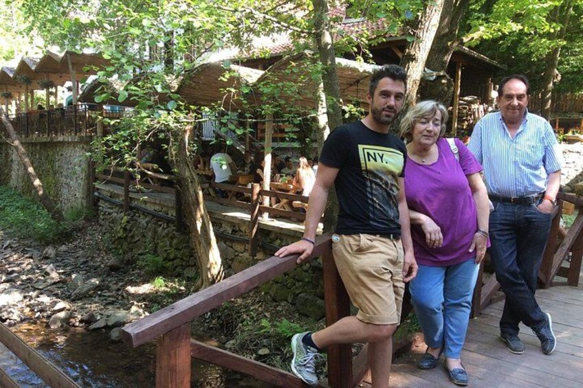 A wooden bridge, a stone wall, and a wooden deck with people standing. 4
