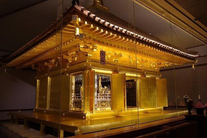 A traditional building with ornate golden detailing and a central shrine. 2