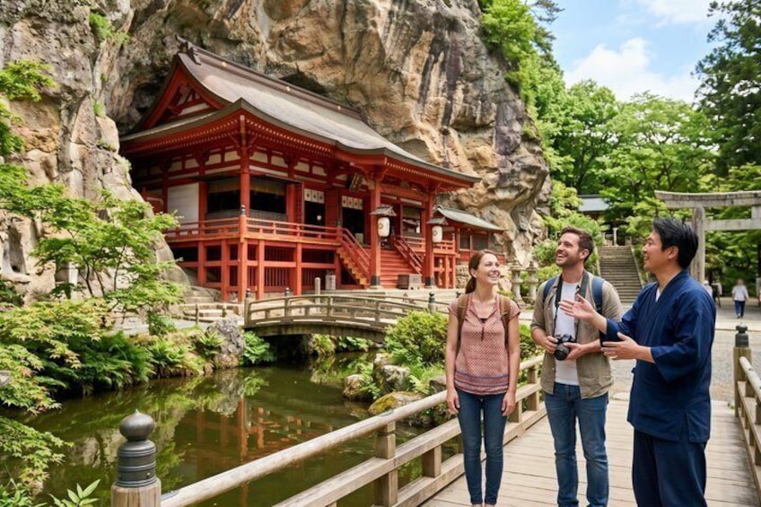 A red traditional building with a wooden bridge in a natural setting. 1