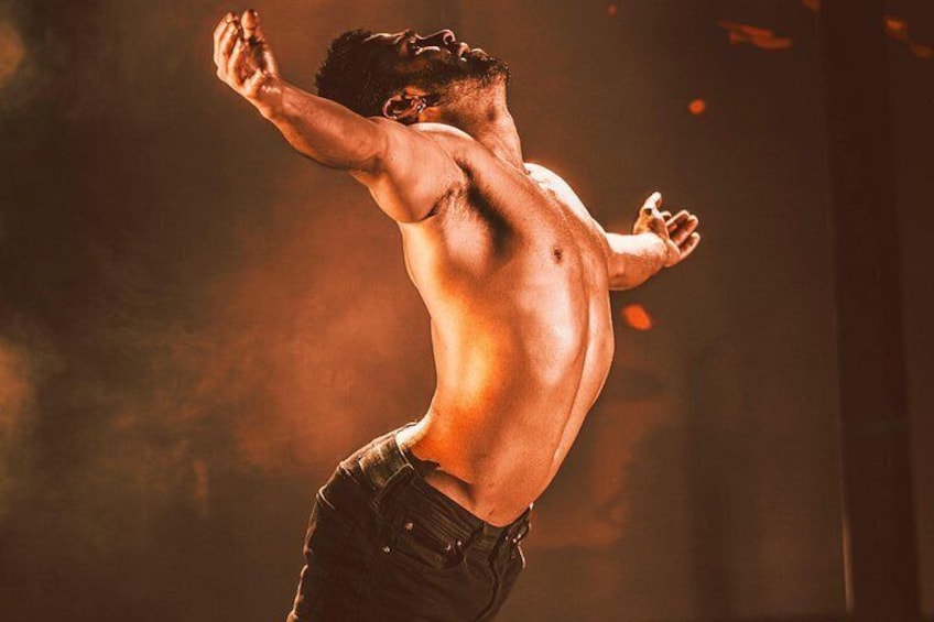 A shirtless man in motion, wearing jeans, with a dynamic pose and a blurred background. 3