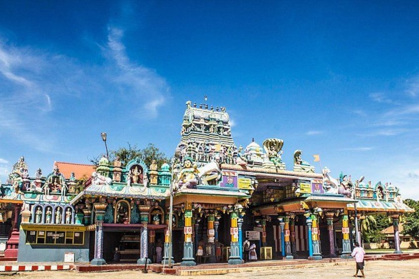 A colorful temple with intricate architecture and multiple statues. 1