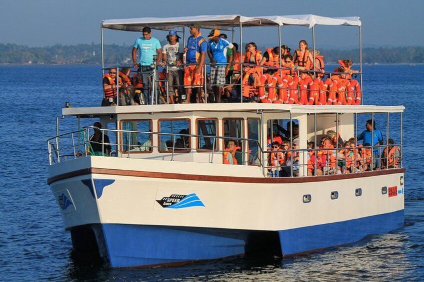 A boat with people wearing life jackets on the water. 4