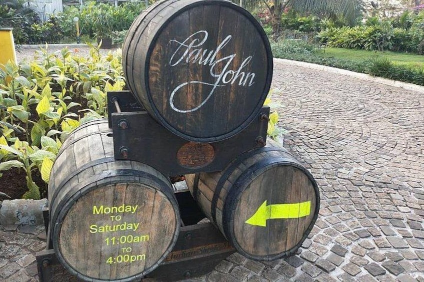 A wooden barrel with 'Paul John' written on it, and another barrel with an arrow pointing to the right. 2