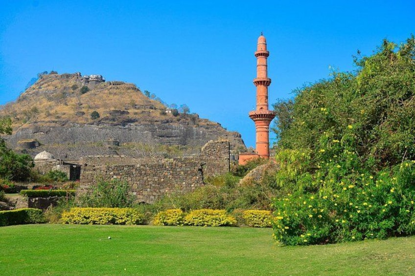 A mosque with a tall minaret, a hilltop building, and a well-maintained garden. 3
