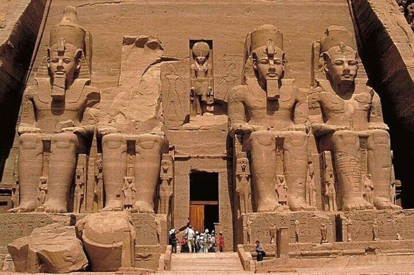 A large ancient Egyptian temple with colossal statues of pharaohs. 2
