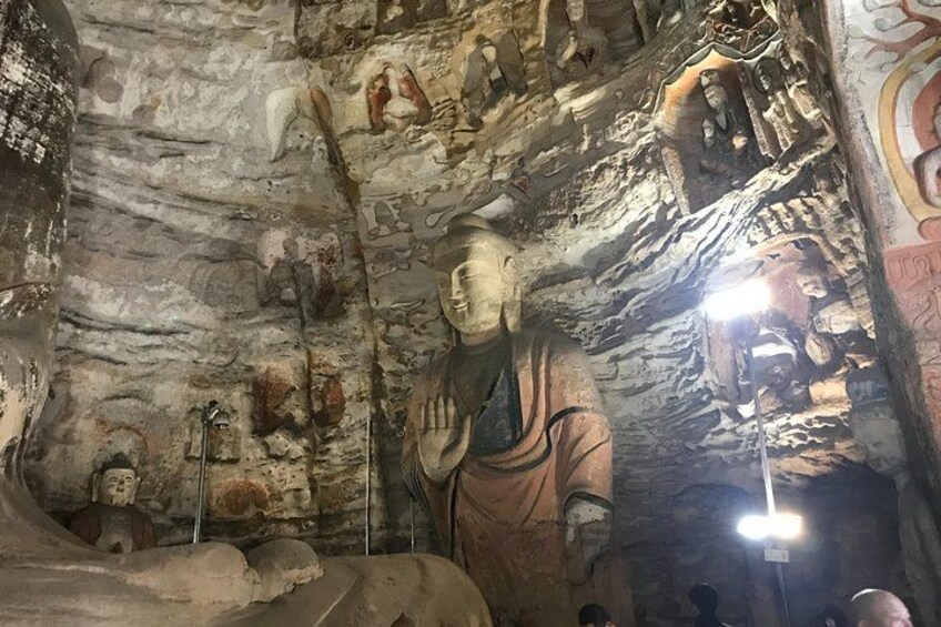 A cave with ancient statues and carvings. 3