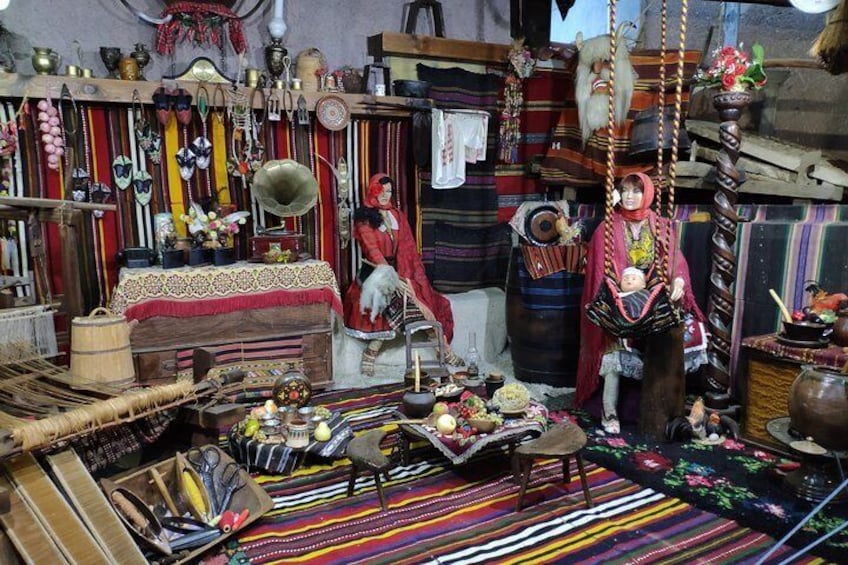 A cluttered room with various objects, including a hanging chair, a mannequin, and a table with items on it. 1