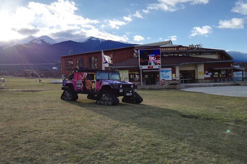 A colorful truck parked in front of a building with a sign that reads "Brewery & Bar." 4