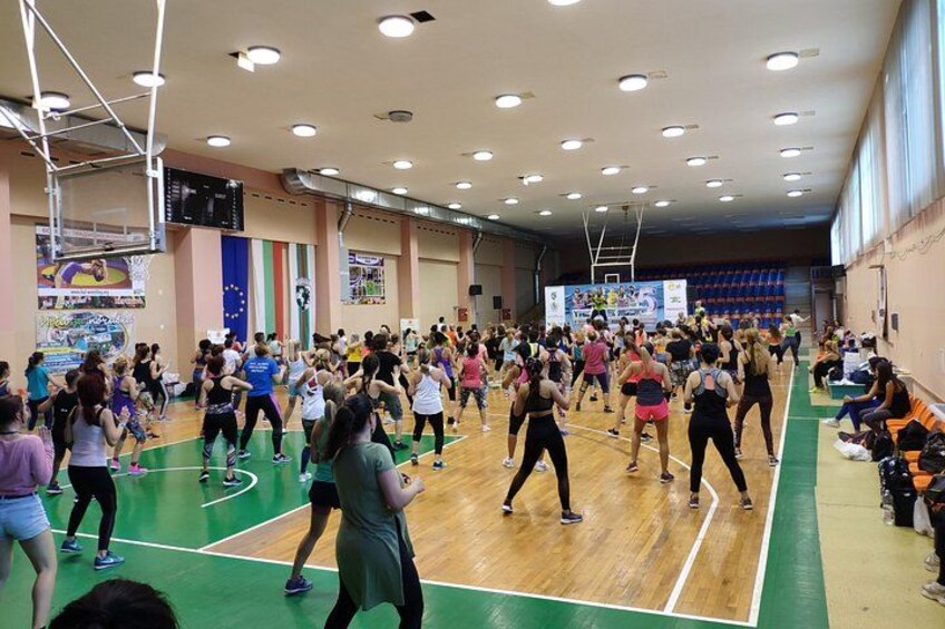 A group of people exercising on a basketball court. 3