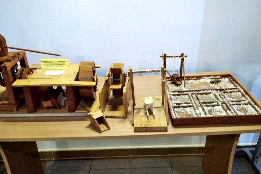 A wooden model of a mechanical device with gears and levers. 1