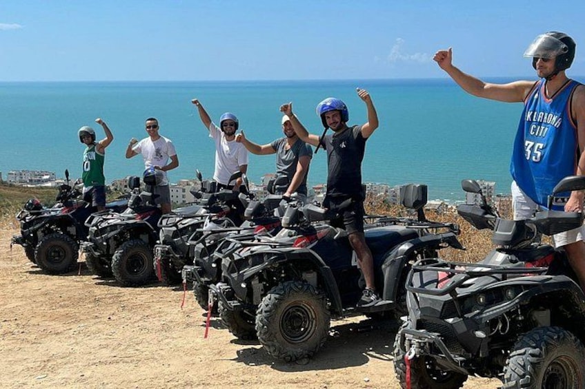 A group of people on ATVs near a coastal area with a clear sky. 2