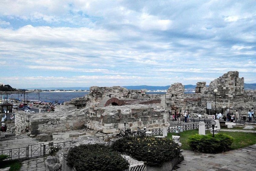 Ancient ruins with stone walls and a sea view. 4