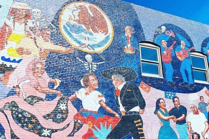 A mural with people dancing, a skeleton, and a globe. 3