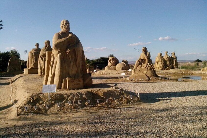 A series of large stone statues in a desert setting. 3