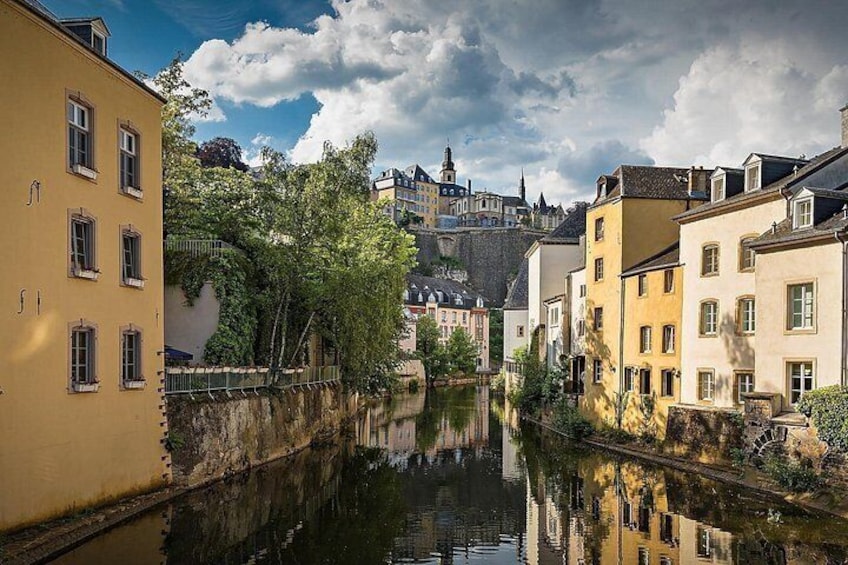 A canal with buildings on either side, a bridge, and a castle in the background. 3
