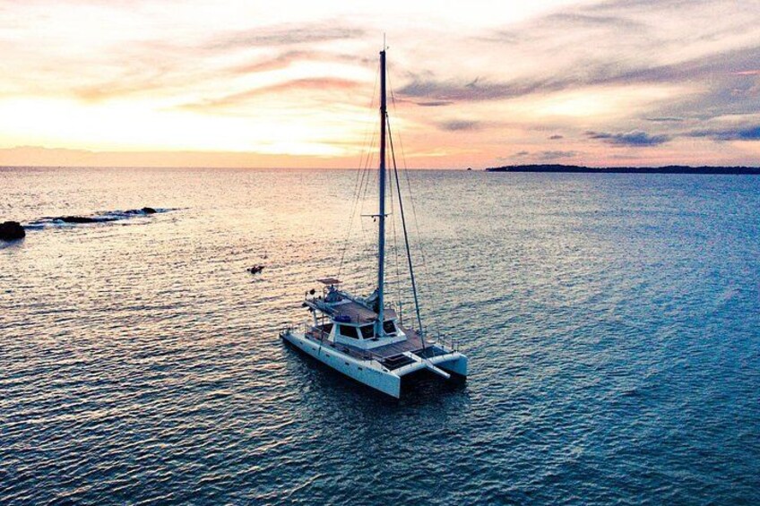 A sailboat on calm waters during sunset. 3