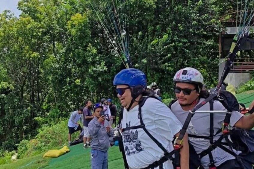 People preparing for a zip-lining activity in a forested area. 4