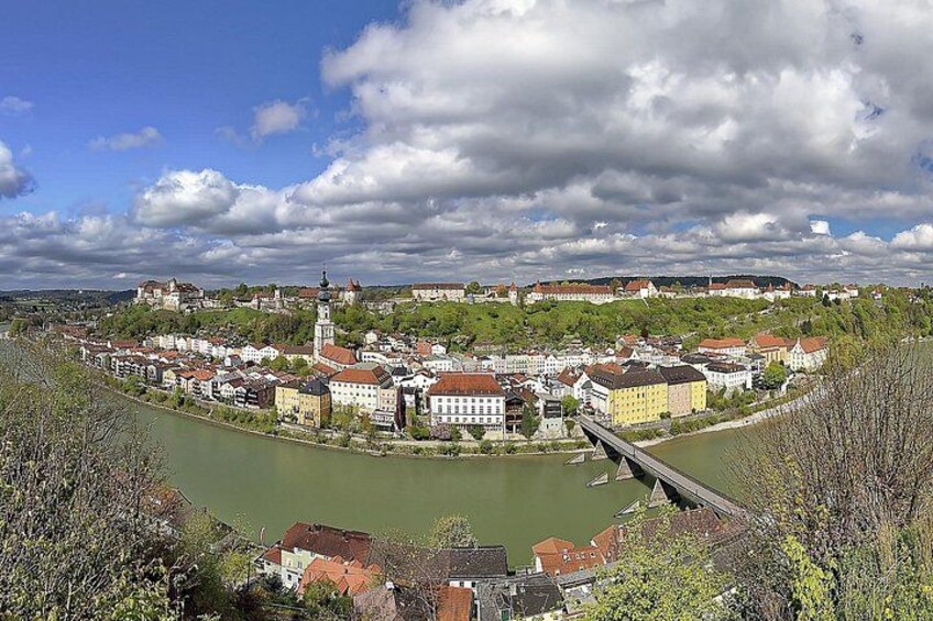 A river flowing through a town with historic buildings and a bridge. 2
