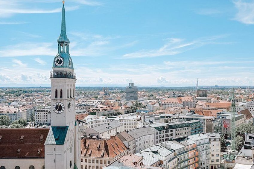 A cityscape with a prominent clock tower and a spire. 4
