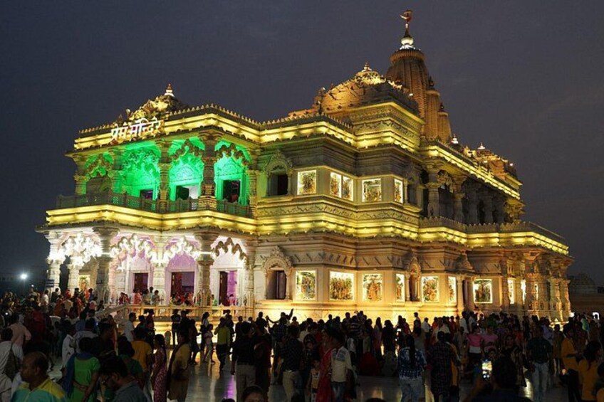 A large, ornate temple with intricate architecture and a crowd of people gathered around it. 4