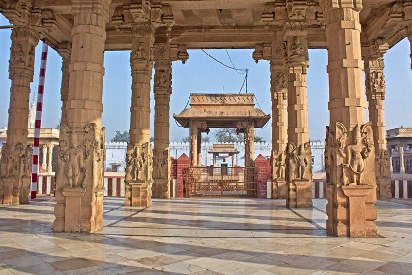A temple with intricate carvings on the pillars and a central shrine. 2