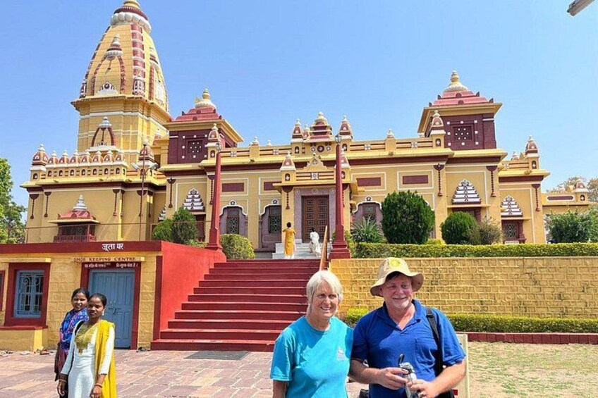 A large, ornate building with a prominent dome and multiple smaller domes, a staircase leading to the entrance, and a sign in a foreign language. 2