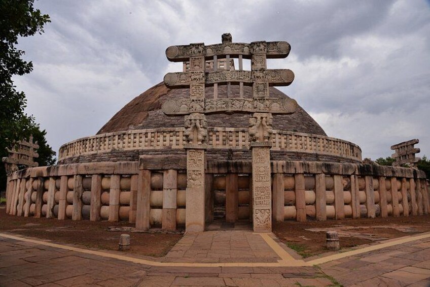 A large, circular stone structure with intricate carvings and a central doorway. 3