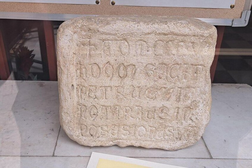 A stone with carved inscriptions. 3