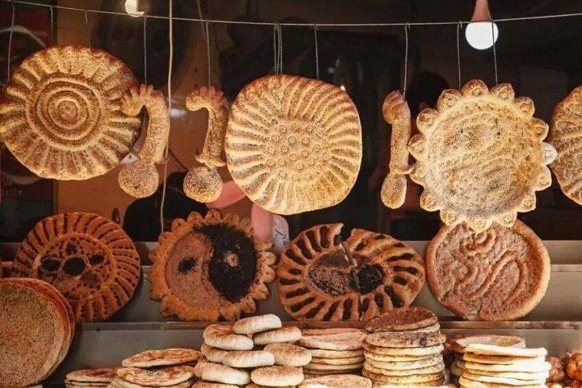 A variety of flatbreads displayed in a shop window. 2