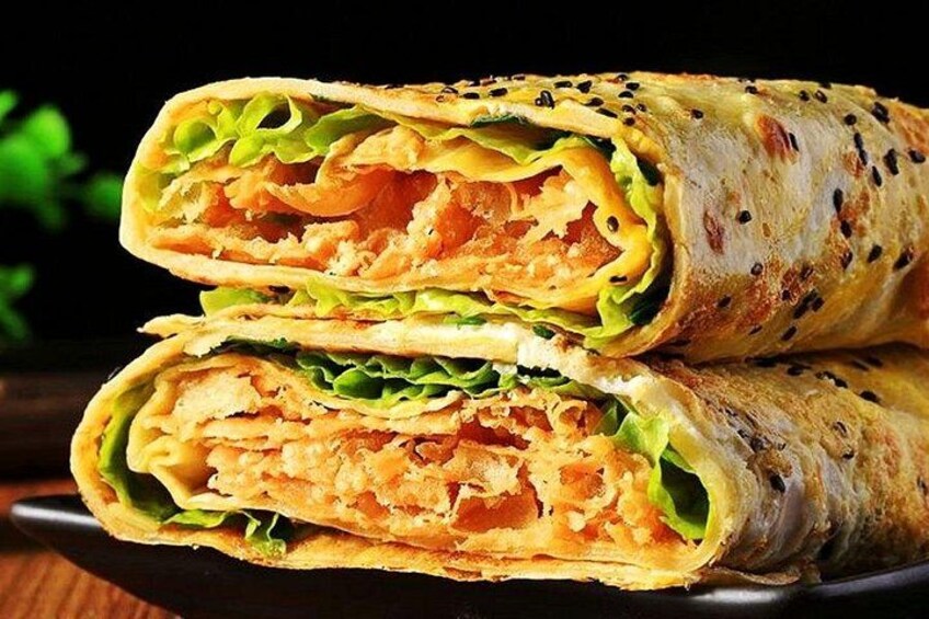 A burrito cut in half, revealing its contents. 5