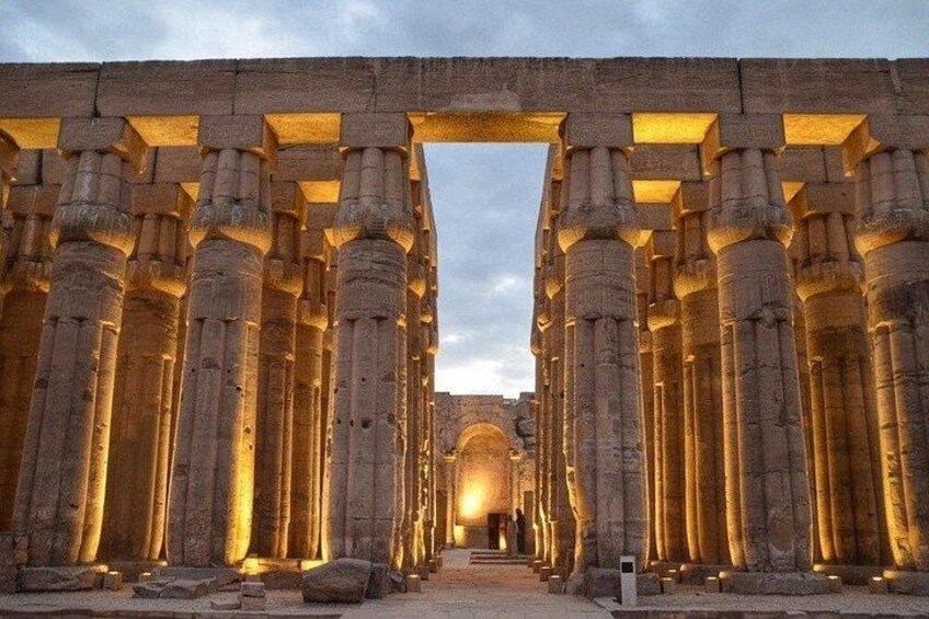Ancient stone columns with warm lighting, creating a grand entrance. 3