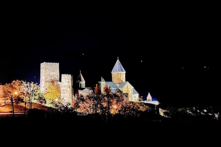 Un castello storico con torri e mura illuminate nella notte. 2
