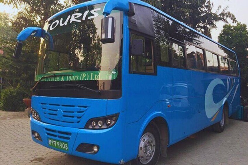 A blue bus with the word "TOURIS" on the front windshield. 1