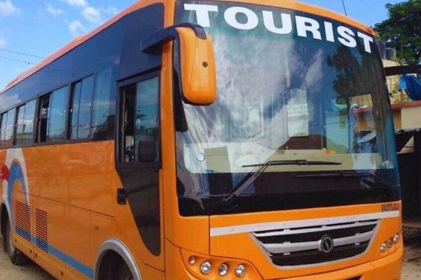A tourist bus with the word 'TOURIST' on the front windshield. 5