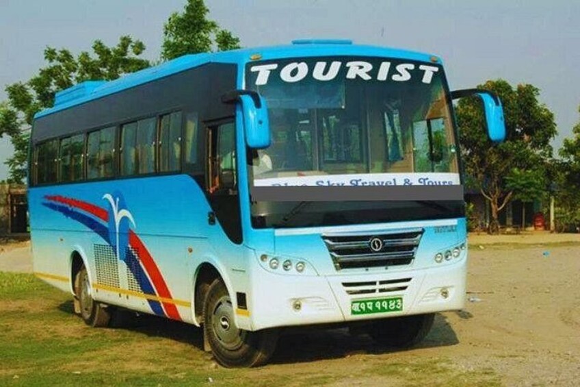 A blue and white tourist bus with the word 'TOURIST' on the front. 4