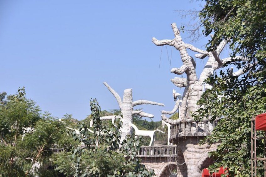 A large, white, tree-like sculpture with branches extending outward. 3