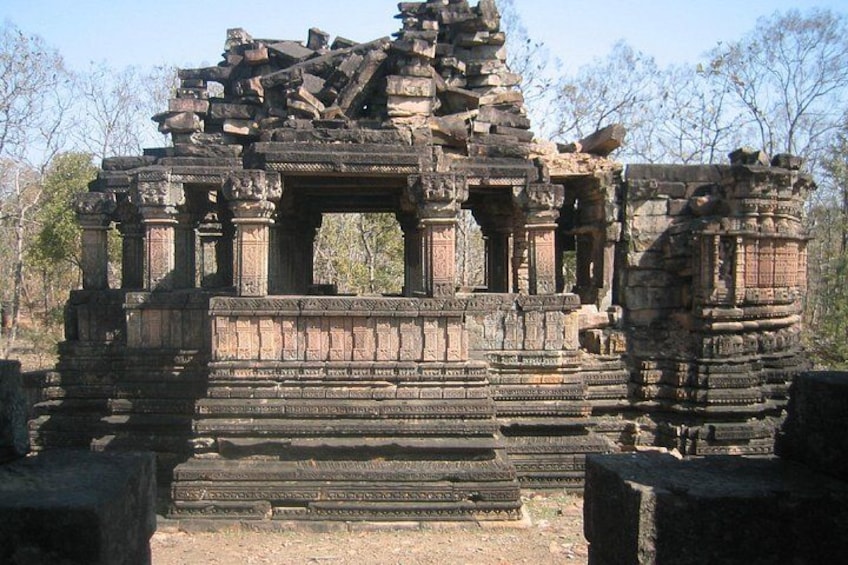 Ancient stone ruins with intricate carvings and stepped platforms. 4