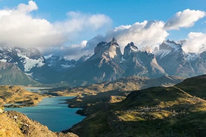 A mountainous landscape with a lake and snow-capped peaks. 1