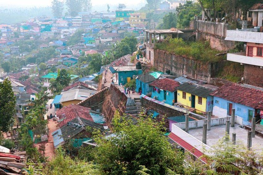 Un pueblo en una ladera con muchas casas de colores y terreno escarpado. 5