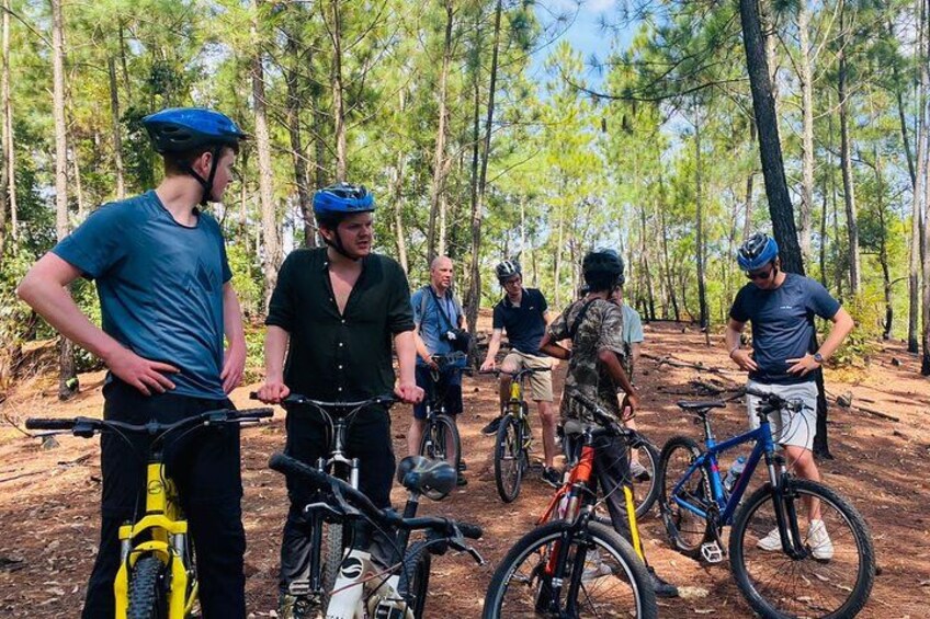 A group of people on bicycles in a forested area. 4