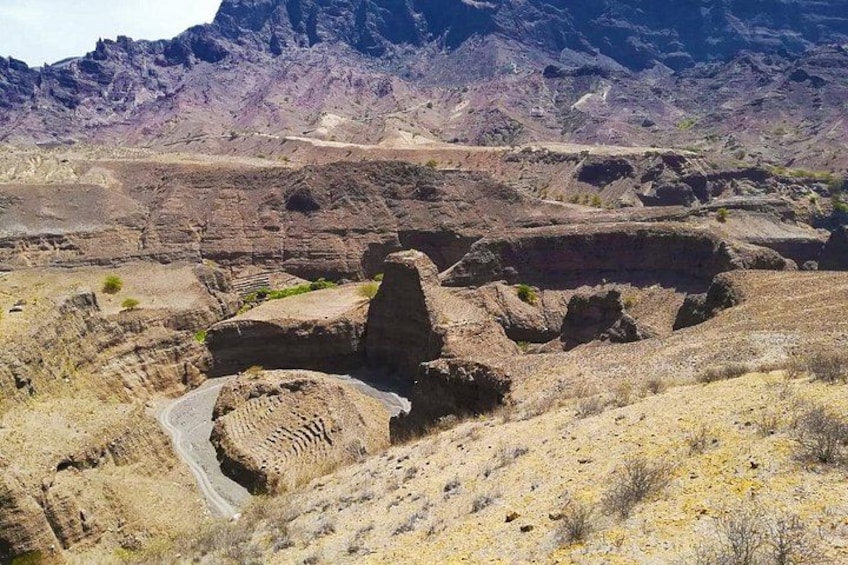 A rugged landscape with rocky terrain and a winding road. 1