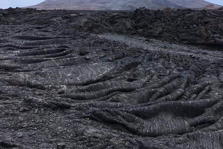 A volcanic landscape with distinctive lava flow patterns. 2