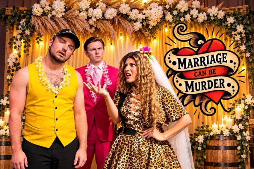 A staged wedding scene with a backdrop featuring a 'Marriage Can Be Murder' sign. 1