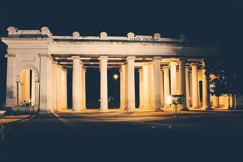 A classical building with columns and a sign reading 'James Princep.' 2