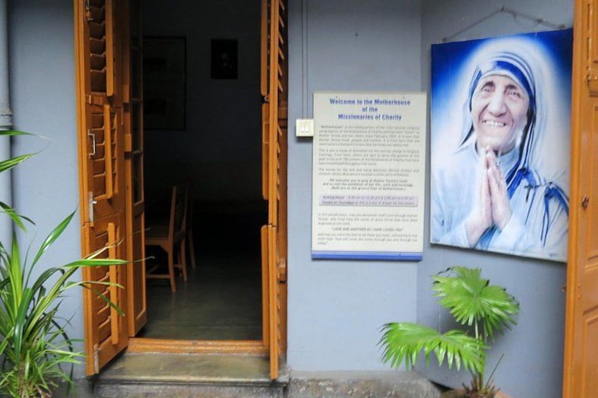 A doorway leading to a room, a poster with text, and a framed picture on the wall. 5