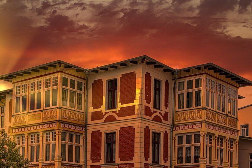 A multi-story building with ornate architectural details, including decorative cornices and window frames. 5