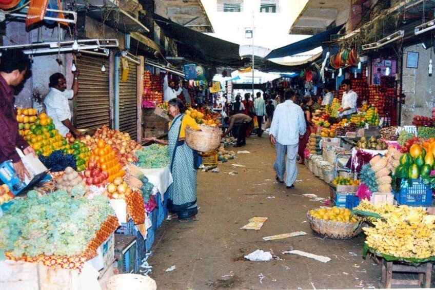 A bustling market with various fruits and vegetables on display. 3