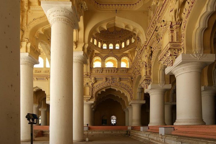 An ornate interior with high ceilings, large columns, and detailed arches. 4
