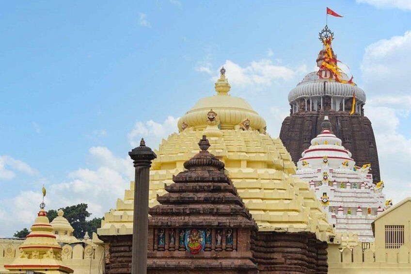 A temple with multiple domes and a flag on top. 2